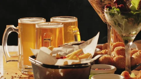 Beer in glasses with set of beer snacks. Assorted deep-fried snacks Stock Footage 239570520