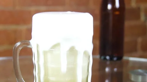 Beer in a large glass mug with high foam very close up Stock Footage 134861336