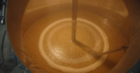 Beer making in craft brewery, Kettle with beer inside, flowing beer. Close up Stock Footage 116132209