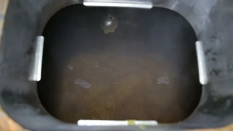 Beer making in craft brewery. Top view kettle with beer inside, flowing beer Stock Footage 99699718