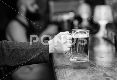 Beer mug on bar counter defocused background. Glass with fresh lager draft beer Stock Photos