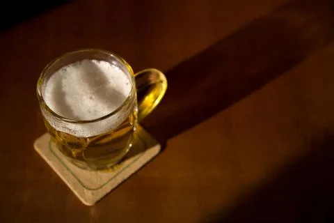 Beer mug on a coaster Stock Photos