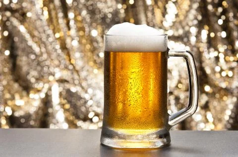 Beer mug in front of a glittering background Stock Photos