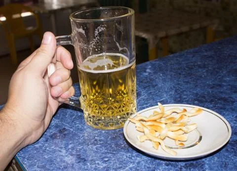 Beer mug in hand Stock Photos