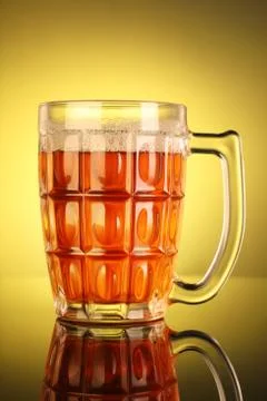 Beer Mug with Yellow Background Stock Photos