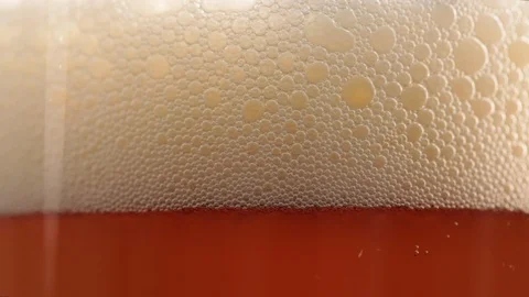 Beer pour with head foam dissipating in glass Video stock 106543161