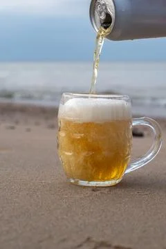 Beer is poured on the beach Stock Photos