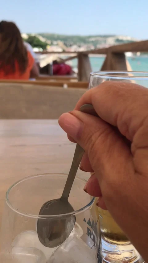 Beer is poured from a bottle into a glass at a table in a restaurant. Stock Footage 158872171