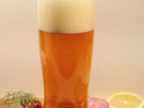 The beer is poured into a glass of bubbles Stock Footage 77007389