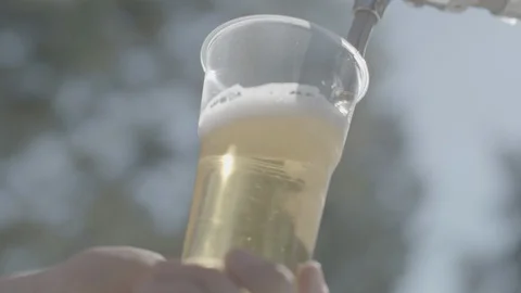 Beer is poured into a plastic cup Stock Footage 111205240