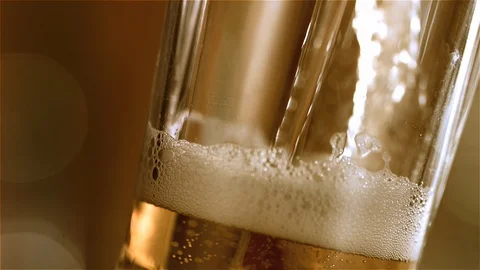 Beer is pouring into angled glass. IPA on tap. Cold Light Beer in a glass Stock Footage 101521804