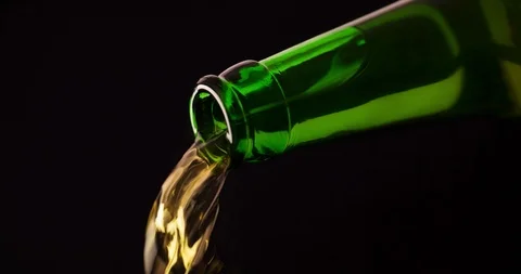 Beer pouring from Bottle closeup macro shot on black background 4K Stock Footage 103637386