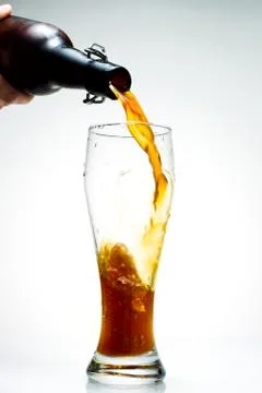 Beer is pouring from a bottle Stock Photos