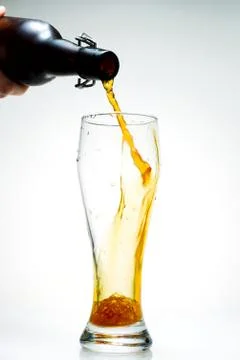 Beer is pouring from a bottle Stock Photos