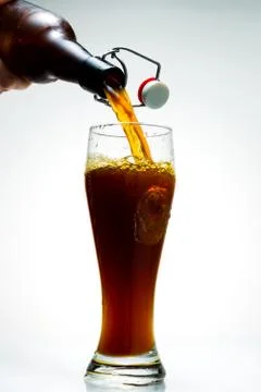 Beer is pouring from a bottle Stock Photos