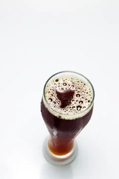 Beer is pouring from a bottle Stock Photos