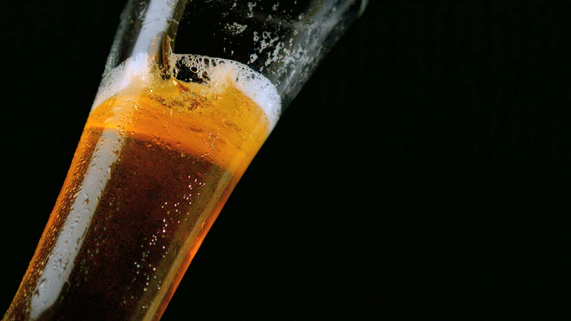 beer pouring glass black background footage 023364633_prevstill