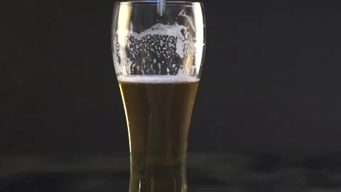 Beer is pouring into a glass Stock Footage 132707972