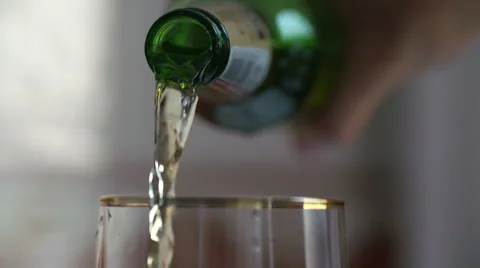 Beer is pouring into the glass in native slow motion scene Stock Footage