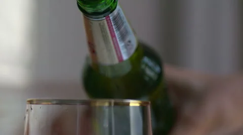 Beer is pouring into the glass in native slow motion scene Stock Footage