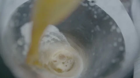 Beer is pouring into the glass in native slow motion scene Stock Footage
