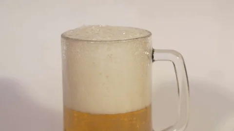 Beer is pouring from the top into glass, slow mo. Stock Footage