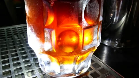 Beer pub. The bartender pours beer into a glass. Stock-Footage 136074117