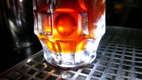 Beer pub. The bartender pours beer into a glass. Stock Footage 136074181