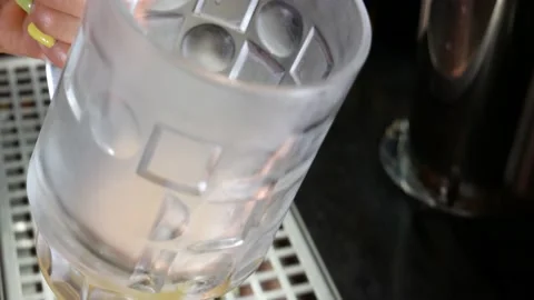 Beer pub. The bartender pours beer into a glass. Stock Footage 136074704