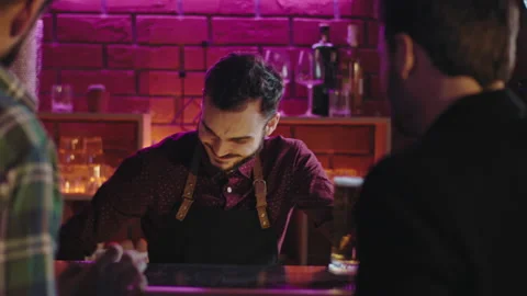 In a beer pub good looking bart enjoying the time at work smiling large he Stock Footage 134180707