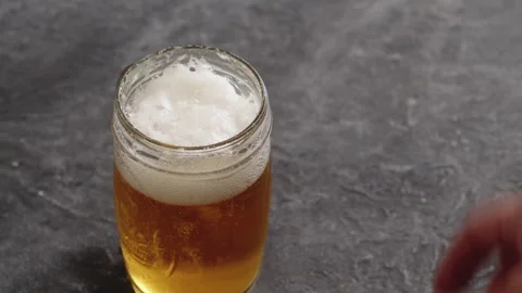 Beer rotating in a classic pint Stock Footage 243595807