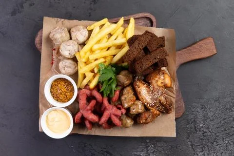 Beer snacks on a chalkboard. On a dark background. Stock Photos