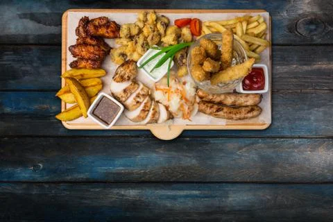 Beer snacks set. Chicken snacks served on cutting board with the wooden Stock Photos