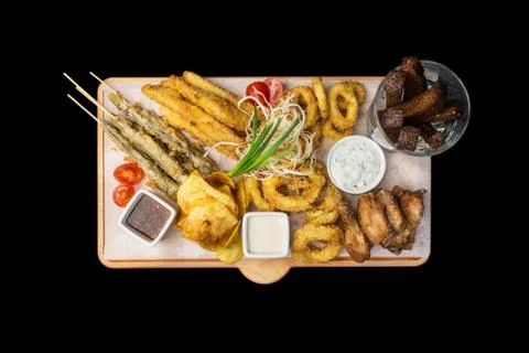 Beer snacks set. Fish set served on cutting board with the mugs, isolated on the Stock Photos