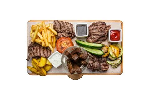 Beer snacks set. Meat set served on cutting board, isolated on a white Stock Photos