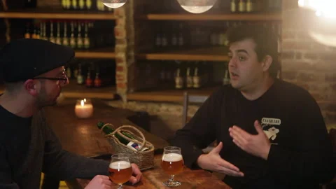 Beer Sommelier Talking over Craft Beer at Cellar Table Handheld Shot 스톡 동영상 346766631