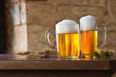 Beer still life on the table with grain and hops Stock Photos