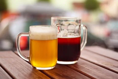 Beer on table - two glasses of beer on wooden table Stock Photos