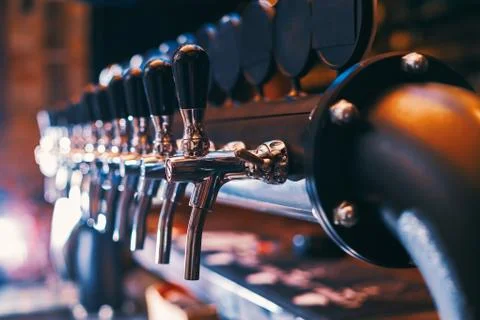 Beer tap array in beer bar Stock Photos