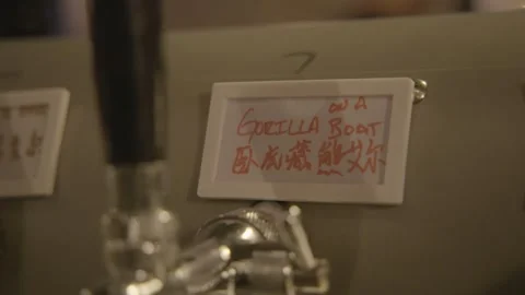 Beer Tap Handle With Handwritten Label in Beijing Bar Interior, China Stock Footage 345760233
