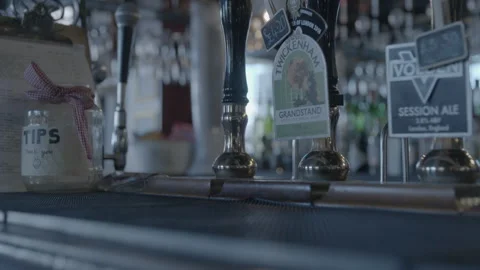 Beer Tap Handles and Tip Jar on Pub Bar Counter Vidéo 343096657