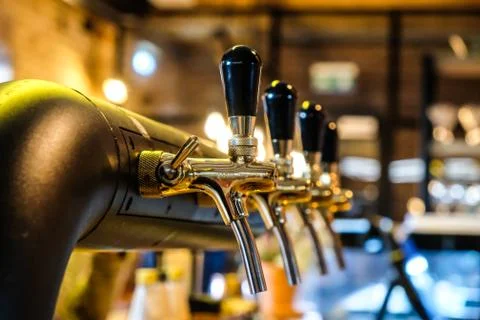 Beer taps at the bar in a row, selective focus Stock Photos