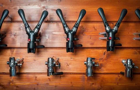 Beer taps for draught drinks are built into wooden boards. Stock Photos