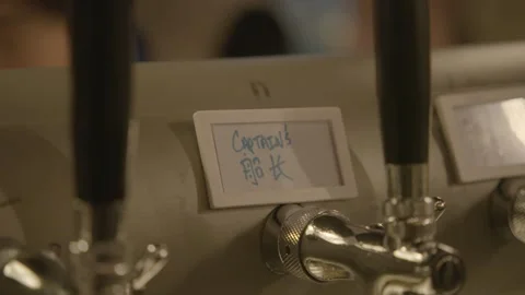 Beer Taps with Handwritten Label in Beijing Bar or Brewery Interior Close-Up Stock Footage 345760009