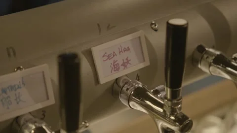 Beer Taps with Handwritten Labels in Bar Interior, Beijing, China Close-Up Stock Footage 345759968