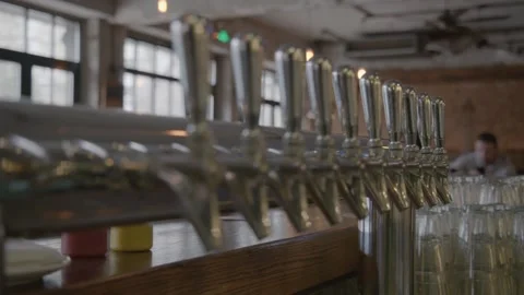 Beer Taps Lined Up on Bar Counter in Beijing Drink Venue Interior with Glassware Stock Footage 345757269