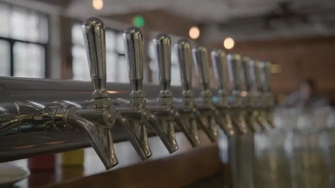 Beer Taps Lined Up in Modern Beijing Bar Interior with Glasses and Patrons Stock Footage 345757376