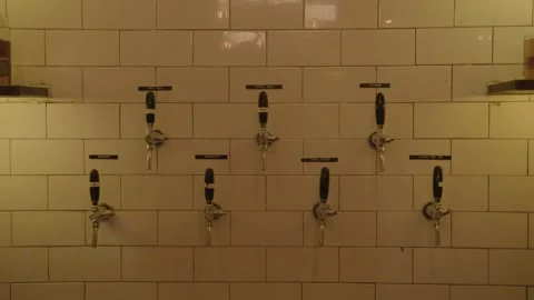 Beer Taps Mounted on White Tiled Wall in Bar Interior, Beijing, China Stock Footage 345755390