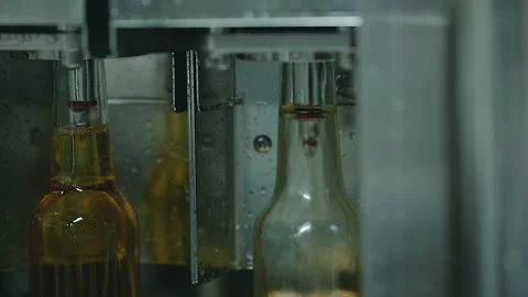 BEERS WHICH ARE BEING FILLED ON A TURNTABLE Stock Footage