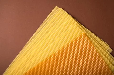 Beeswax honeycomb sheets on brown background Stock Photos